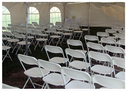 White chairs in a tent for a wedding